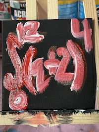 a painting with red and black paint on it